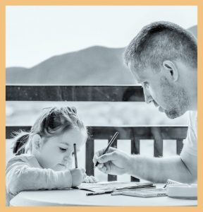 Child studying with father signifying the importance of parent engagement in student learning