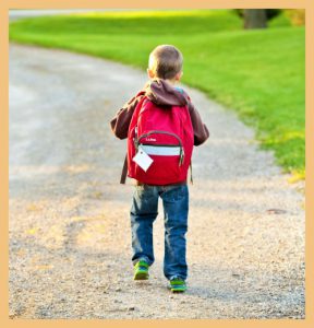 Boy with bag walking to school signifying the relevance of a school's vision