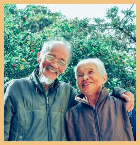 Smiling elderly couple signifying the characteristics of 'eudaimonia'