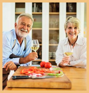 Elderly couple enjoying wine and food signifying impact of guiding guest experiences