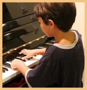 Child playing the piano signifying the power of 'deep learning'
