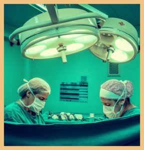 Two medics in operating theatre signifying better operating metrics in hospital