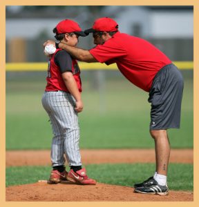 Baseball coach with young student signifying the benefits accrued from teacher leaders