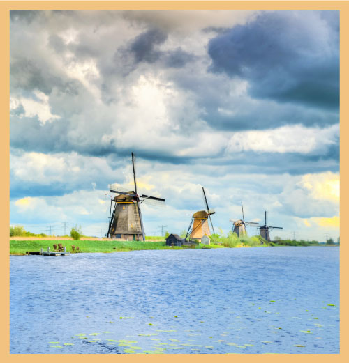 Row of windmills next to a lake signifying the mindfulness of business processes