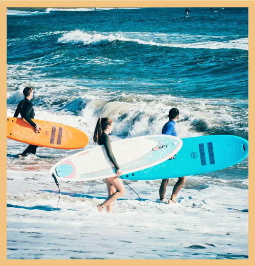 Surfers with boards signifying reviews in business planning and strategy performance transformation