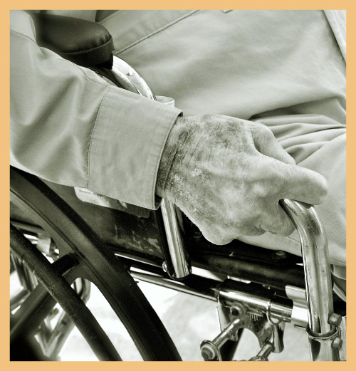 Hand of patient on wheelchair signifying the impact of strong hospital vision and strategy