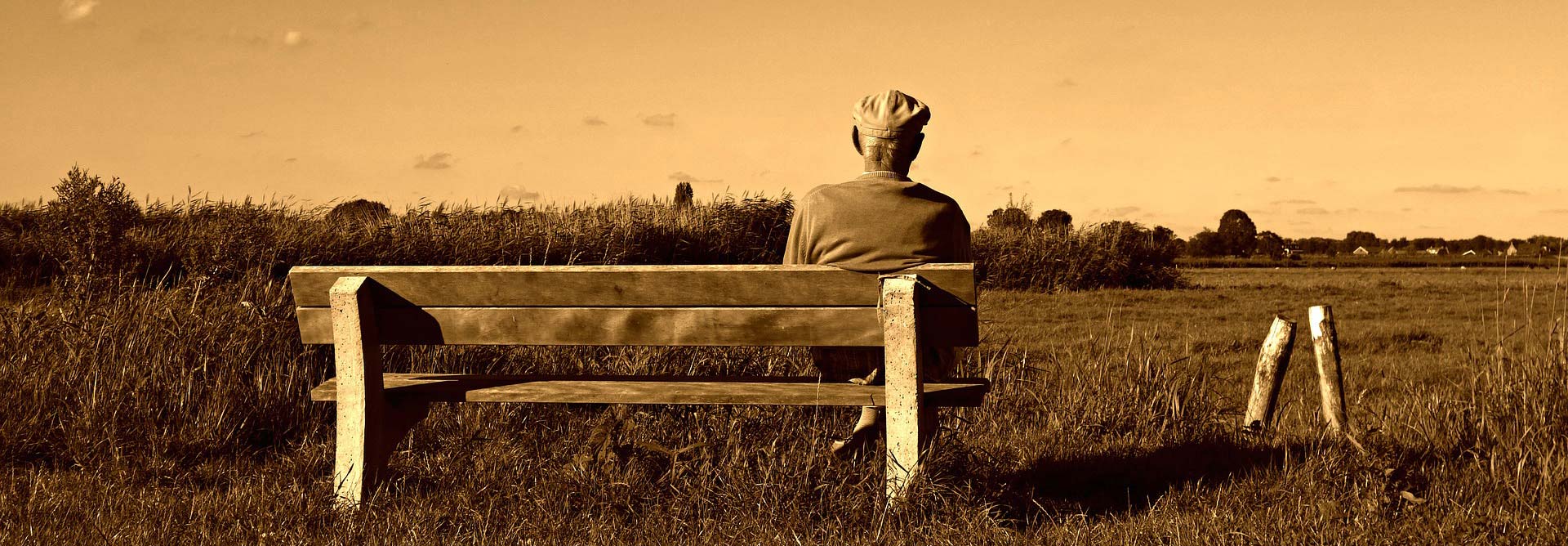 Elderly man sitting on bench signifying the impact of strong care standards