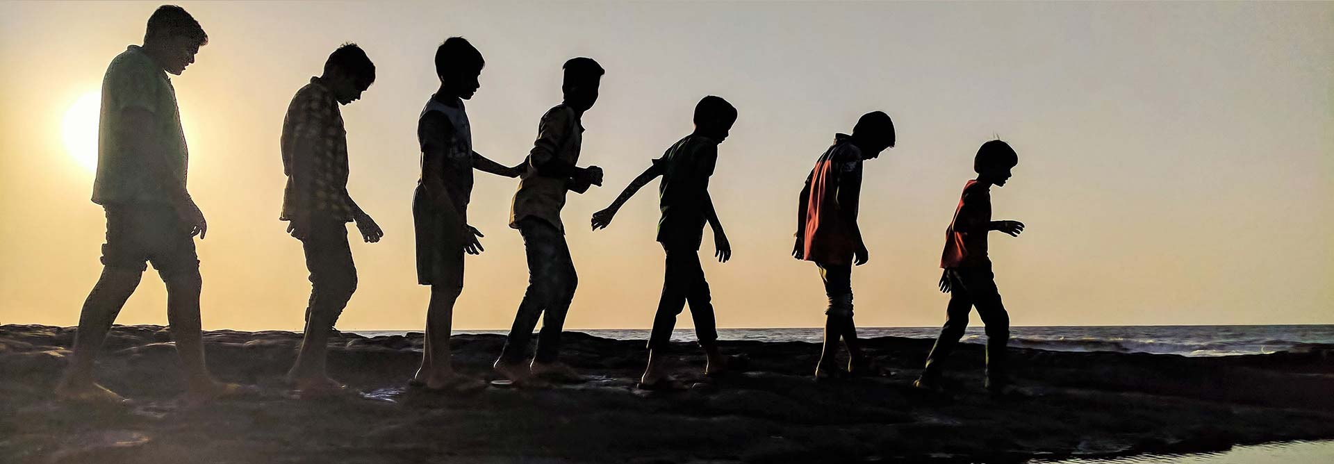 Silhouette of seven boys walking with different postures signifying differing learning preferences