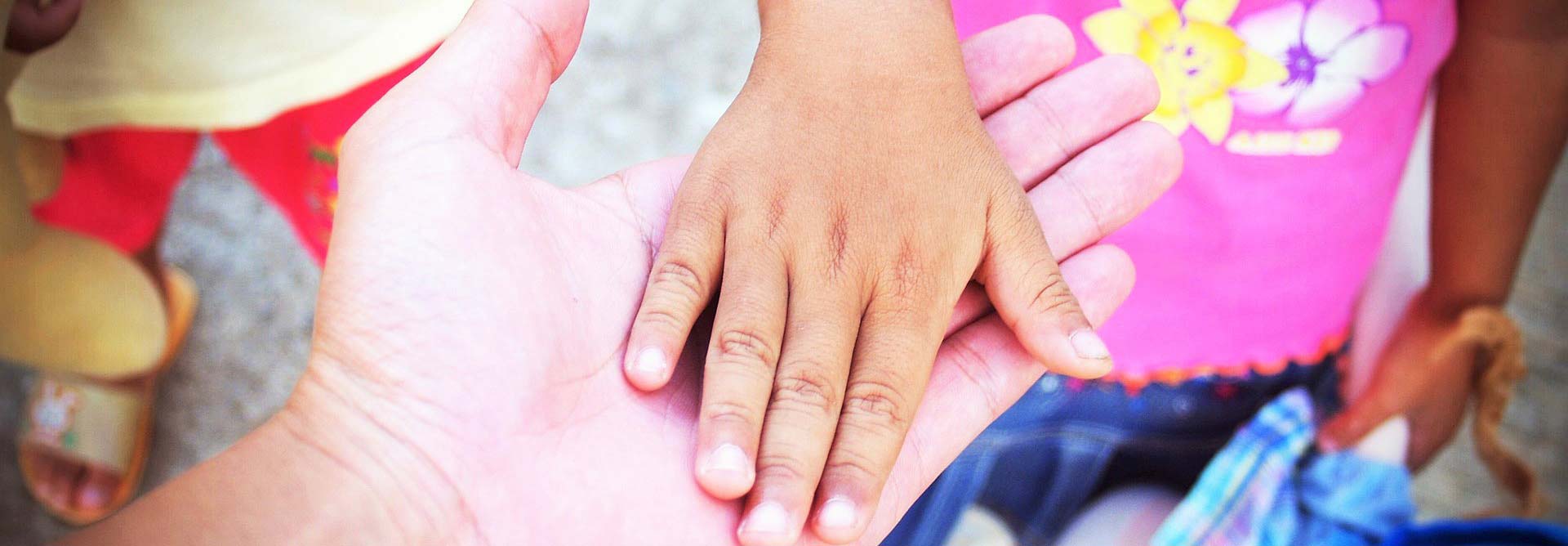 Child's hand on a nurse's signifying motivated nursing community
